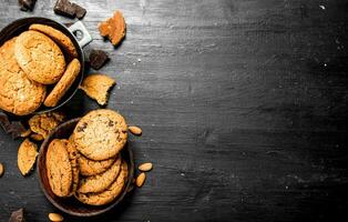 Oatmeal cookies in a bowl with almonds. photo