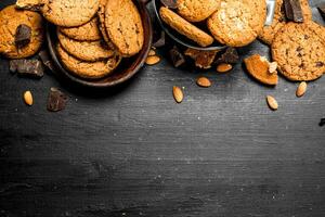 Oatmeal cookies in a bowl with almonds. photo