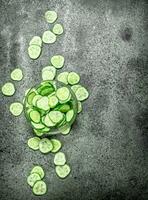 Slices of fresh cucumbers in a bowl. photo