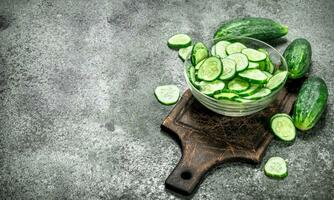 Slices of fresh cucumbers in a bowl. photo