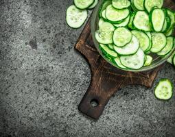 Slices of fresh cucumbers in a bowl. photo