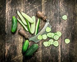 Freshly cut cucumbers with a knife. photo