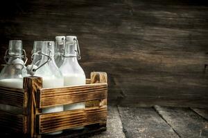 Bottles with fresh milk in a box. photo