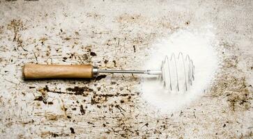 Preparation of the dough. Whisk with the flour. photo