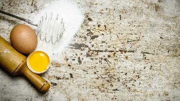 Preparation of the dough. Ingredients for the dough - Flour , eggs and rolling pin. photo