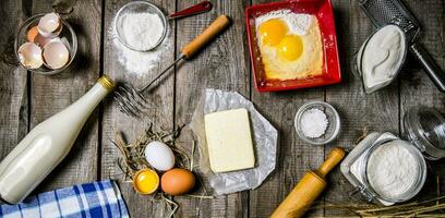 Preparation of the dough. Ingredients for the dough - milk, cream, butter, flour, salt, eggs and different tools. photo