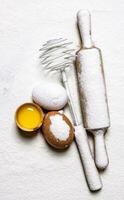 Eggs with venicom and rolling pin in flour. photo