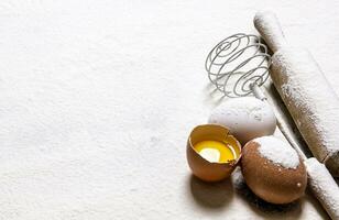 Eggs with venicom and rolling pin in flour.  Free space for text . photo
