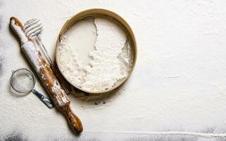 Preparation of the dough .Sieve with a rolling pin and flour. photo