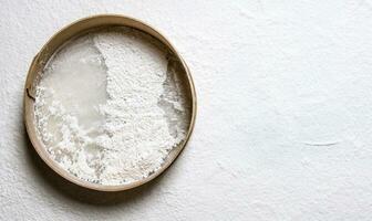 Baking the dough , wooden sieve with flour. photo