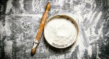 Preparation of the dough. Sieve the flour and with a rolling pin. photo