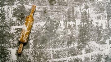 Baking background with a rolling pin with flour. photo