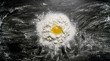 Preparation of the dough . The egg with the flour. photo