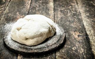 Fresh dough on board. photo