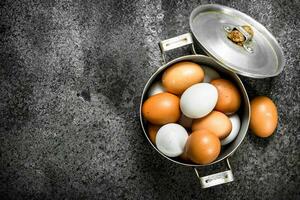 Fresh eggs in a saucepan. photo