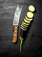 Fresh eggplants with an old knife and slices. photo