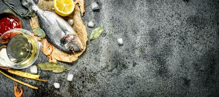 Unprocessed Dorado fish with spices and lemon. photo