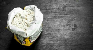 Flour in a paper bag. photo