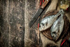 Raw Dorado fish with hot chili peppers. photo