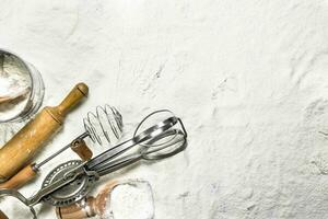 Various baking tools on flour. photo