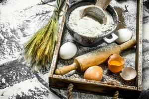 Dough backround. Flour with eggs and rolling pin. photo