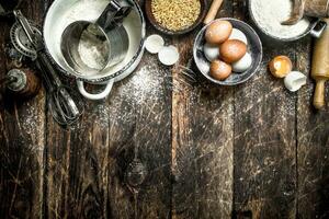 Dough background. Flour with wheat grains and fresh eggs. photo