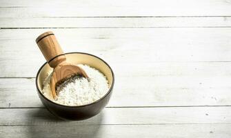 Flour with a scoop in a bowl. photo