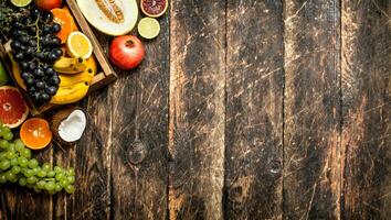 Various ripe fruits in a wooden box. photo