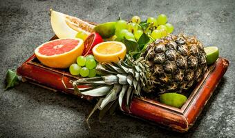 Ripe fruits in the old tray. photo