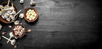 Fresh garlic in wooden bowls. photo