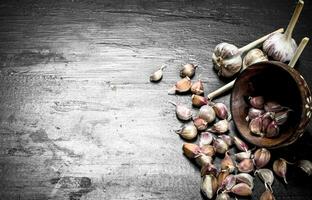 Pieces of fresh garlic in a wooden bowl. photo