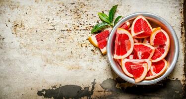 Pieces of sliced grapefruit in a cup . photo