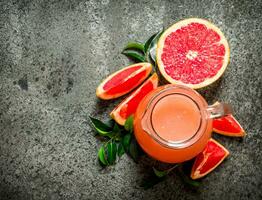 Fresh juice from grapefruits. photo