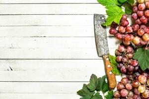 Bunches of red grapes with leaves. photo