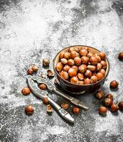 Hazelnuts in a bowl with a Nutcracker. photo