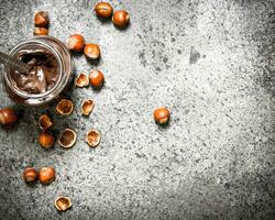 nut butter from hazelnuts and chocolate. On rustic background. photo