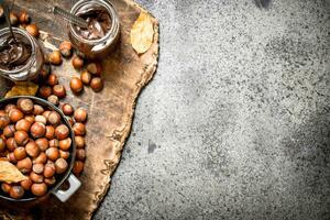 nut butter from hazelnuts and chocolate. On rustic background. photo