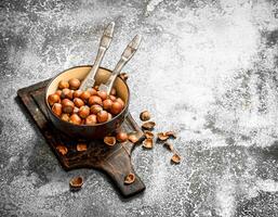 Hazelnuts in a bowl with a Nutcracker. photo
