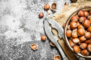 Hazelnuts in a bowl with a Nutcracker. photo