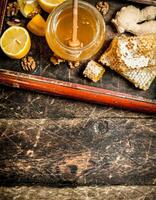 Honey background . Fresh honey with lemon and ginger in an old tray. photo