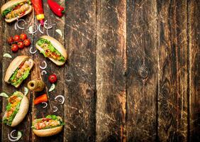 Street food. Hot dogs with mustard, hot sauce , onion and greens. photo