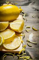 Cut the lemon zest on the Board. On wooden table. photo