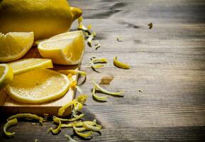 Cut the lemon zest on the Board. On wooden table. photo