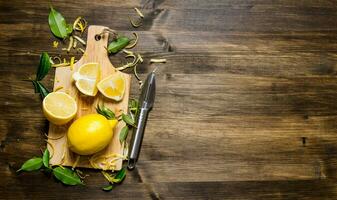 Sliced lemon on the board with leaves. photo