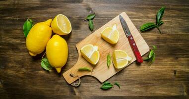 Sliced lemon on the board with leaves. photo