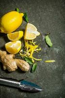 Lemon zest, ginger and leaves on a stone stand. photo