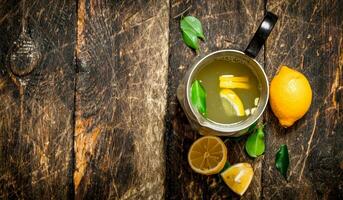 Fresh lemonade in a jug with slices of lemon . photo