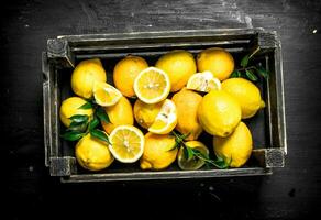 Fresh lemons in a wooden box. photo