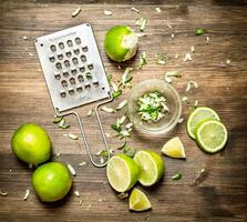 Fresh limes with grater and zest. photo