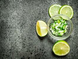 Zest lime slices in a bowl . photo